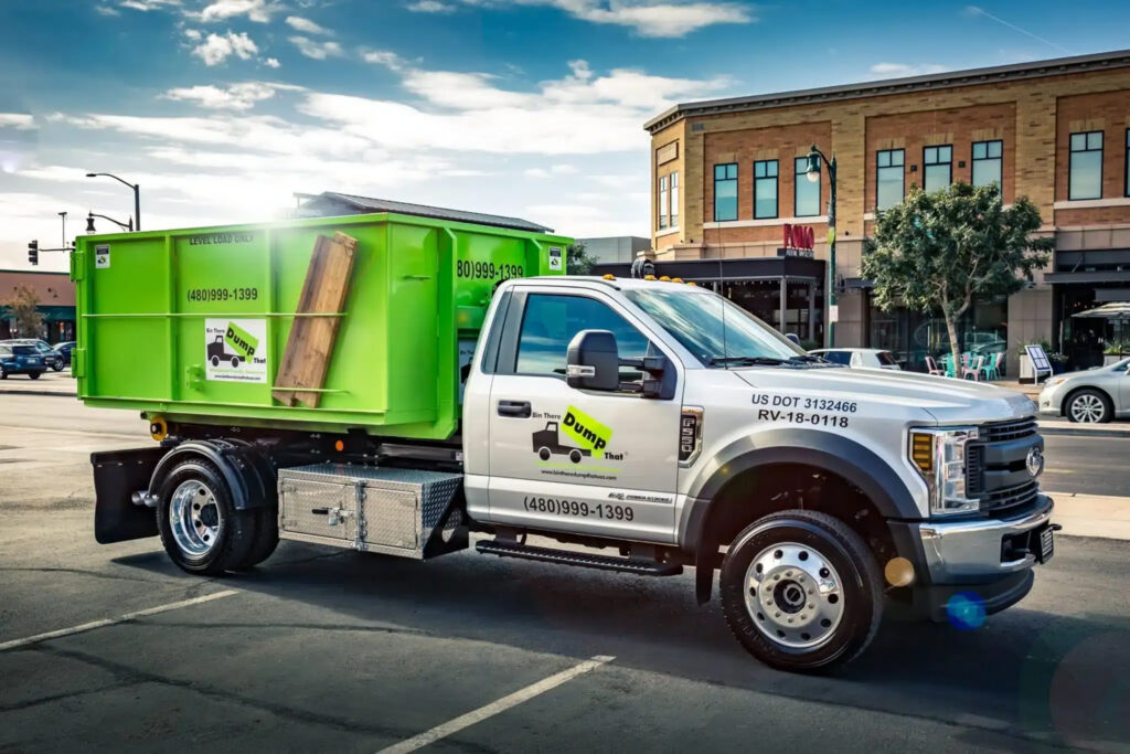 A Bin There Dump That truck and bin parked on a city street in sunset