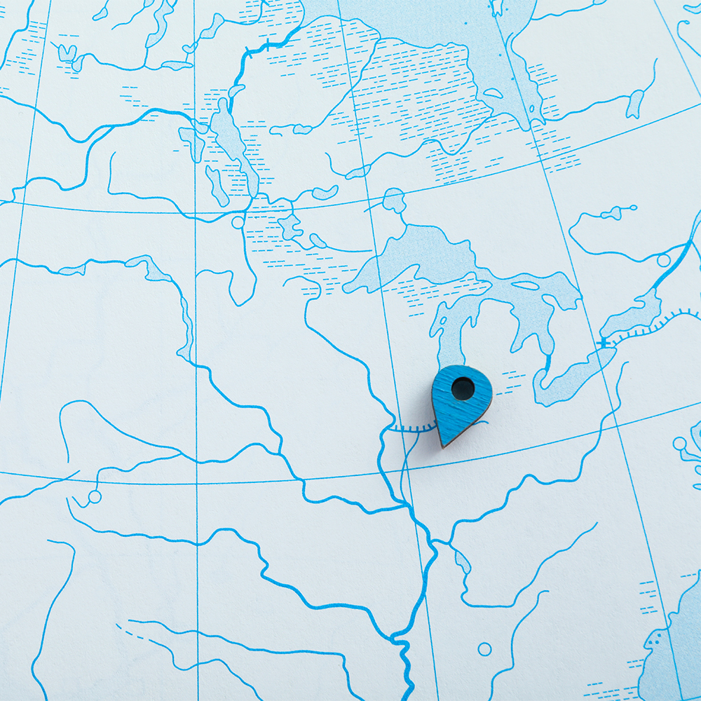 An illustrated world navigation map is seen with a light blue background.